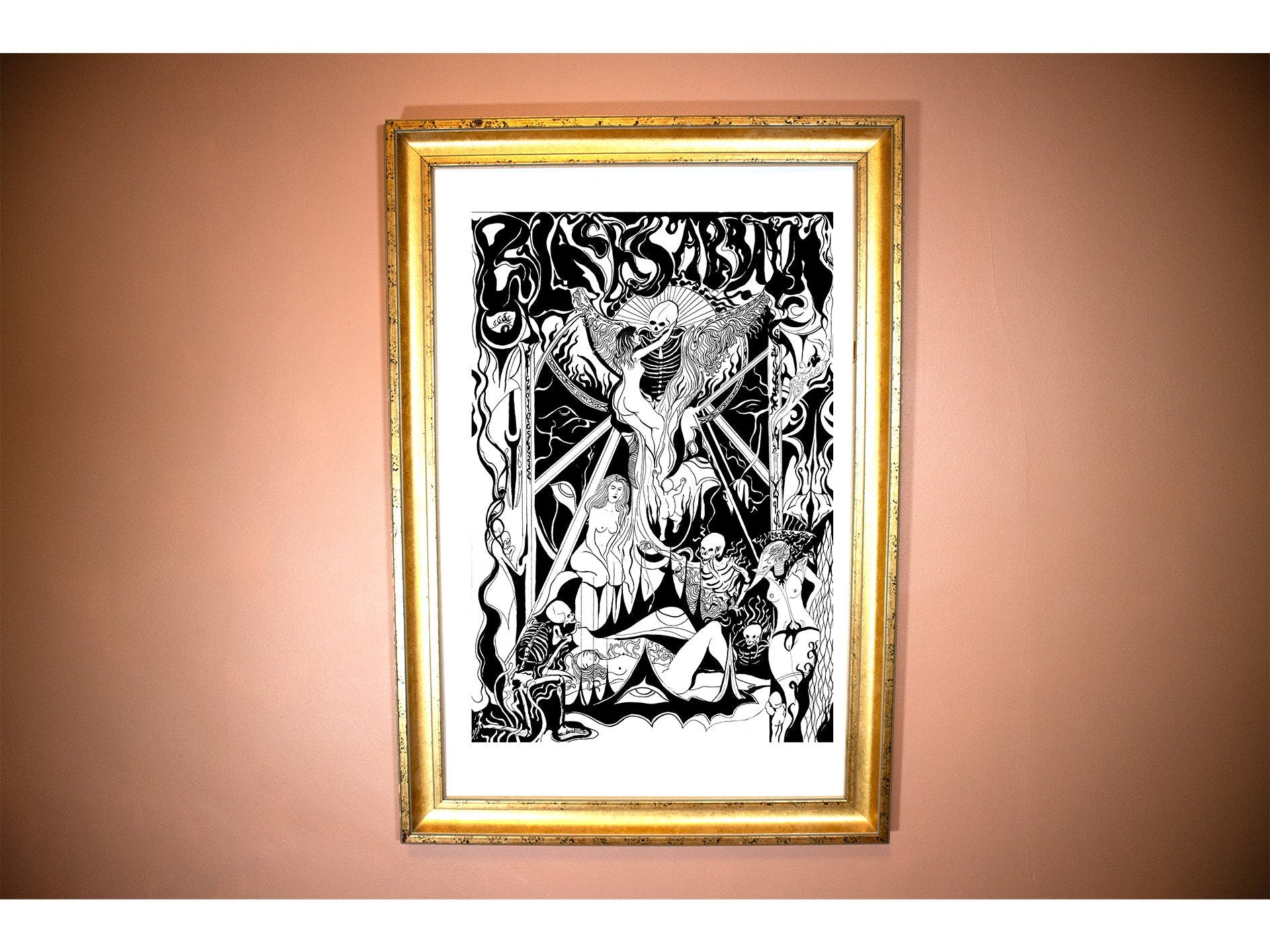 a framed picture of  A black and white gothic pen and ink poster for the band black sabbath in an art nouveau style showing a black mass conducted by demons and Skelletons