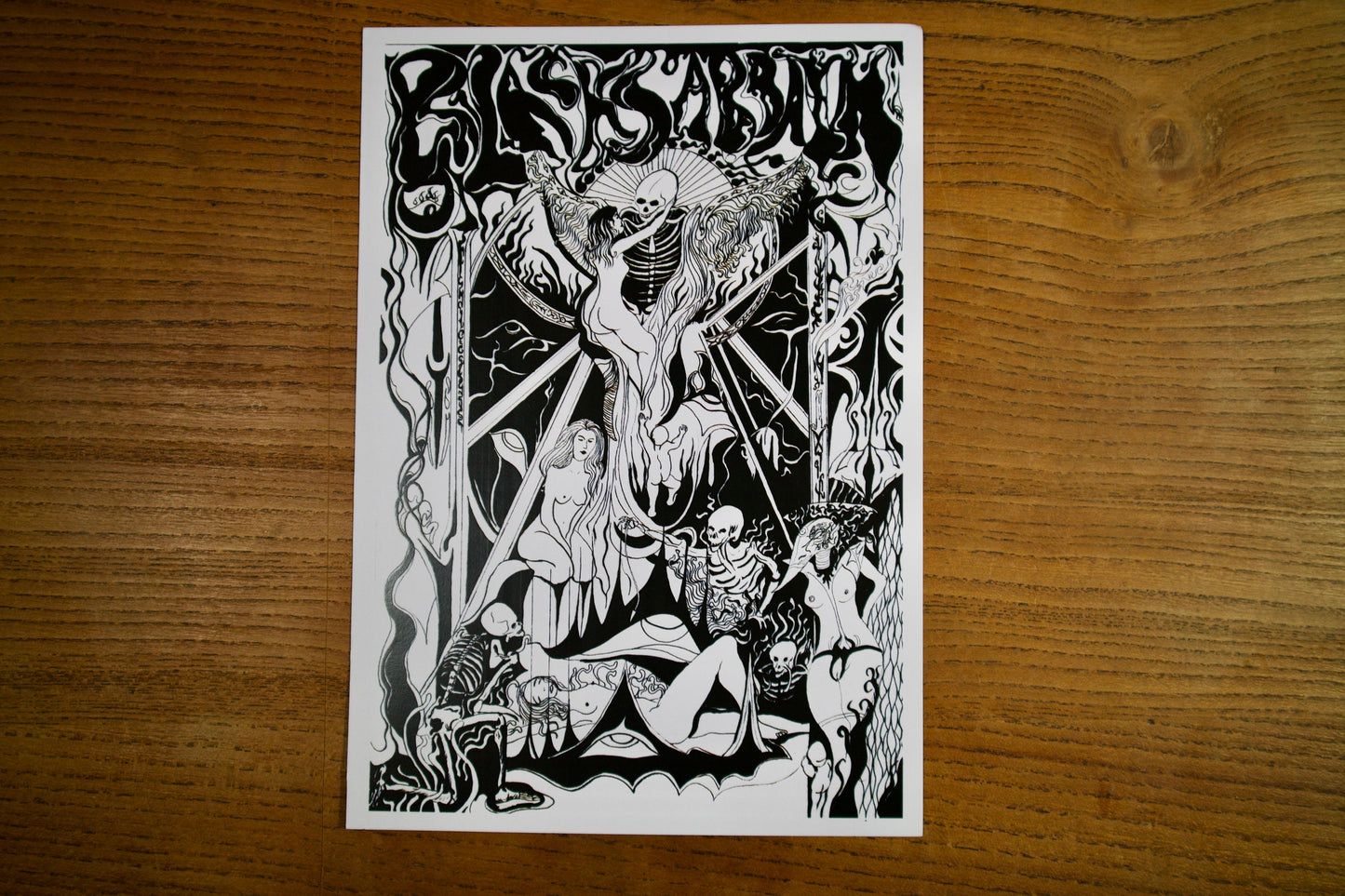 1 A5 print of  A black and white gothic pen and ink poster for the band black sabbath in an art nouveau style showing a black mass conducted by demons and Skelletons